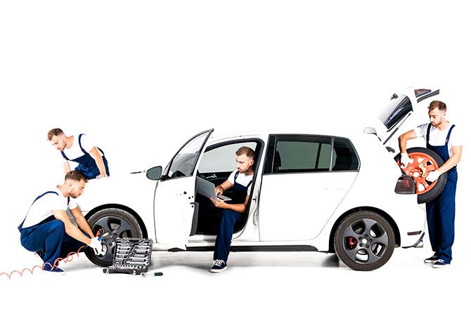 Maximize Your Dealership’s Warranty Service Reimbursements; A mechanic is seen in four different positions around a white car on a white background: working on a tire, using a laptop, and holding a spare tire.
