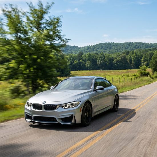 Luxury car driving on rural road